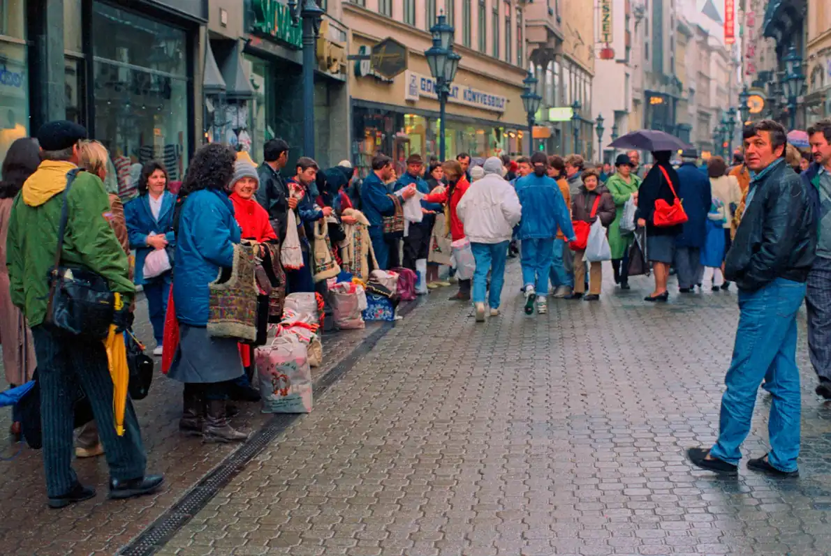 People browsing stalls along a busy pedestrian street