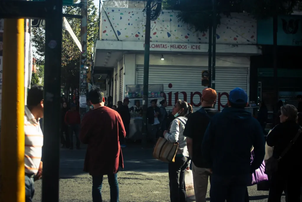 Pedestrians walking between urban shopfronts
