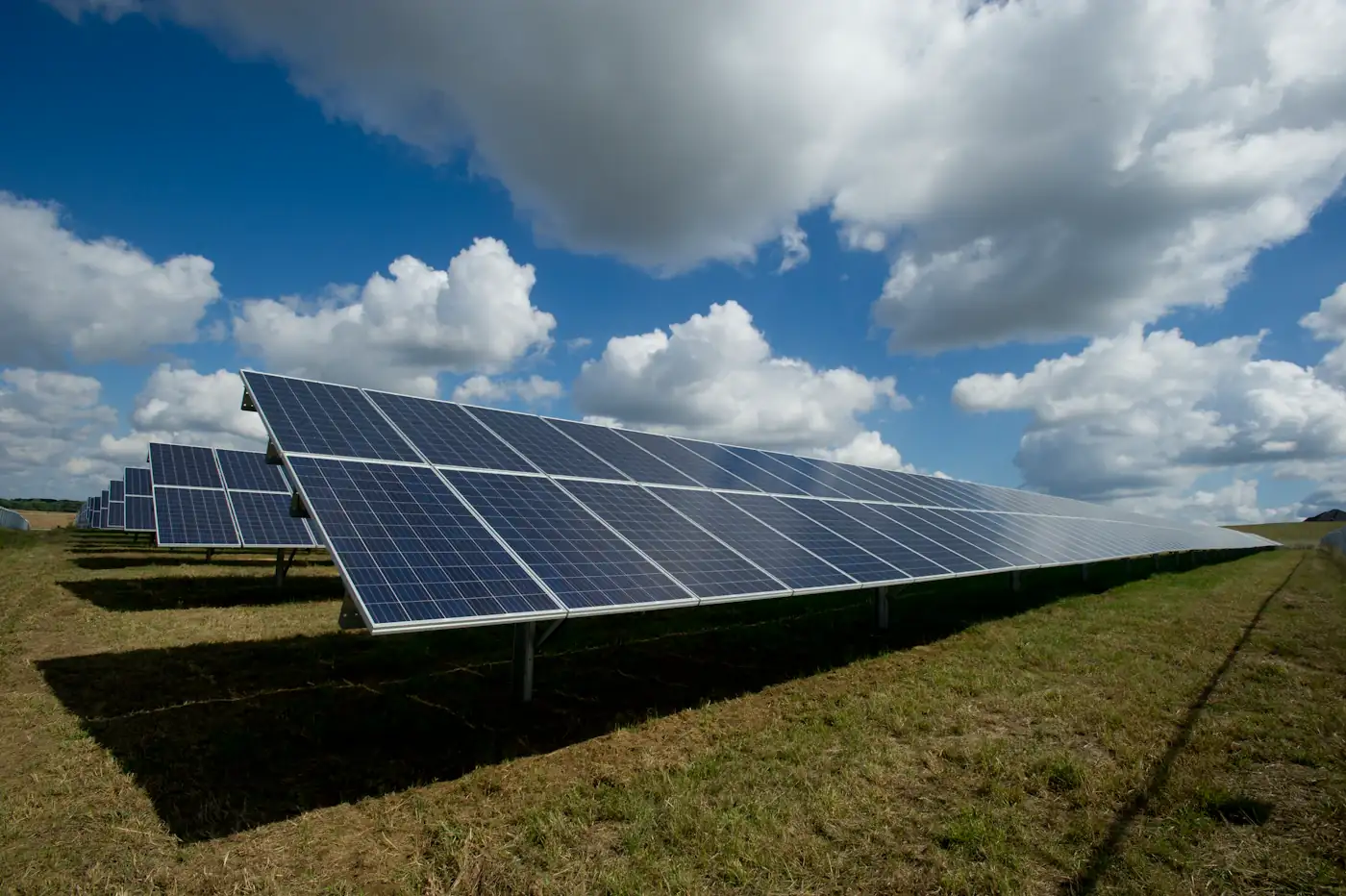 Rows of solar panels beneath clouds