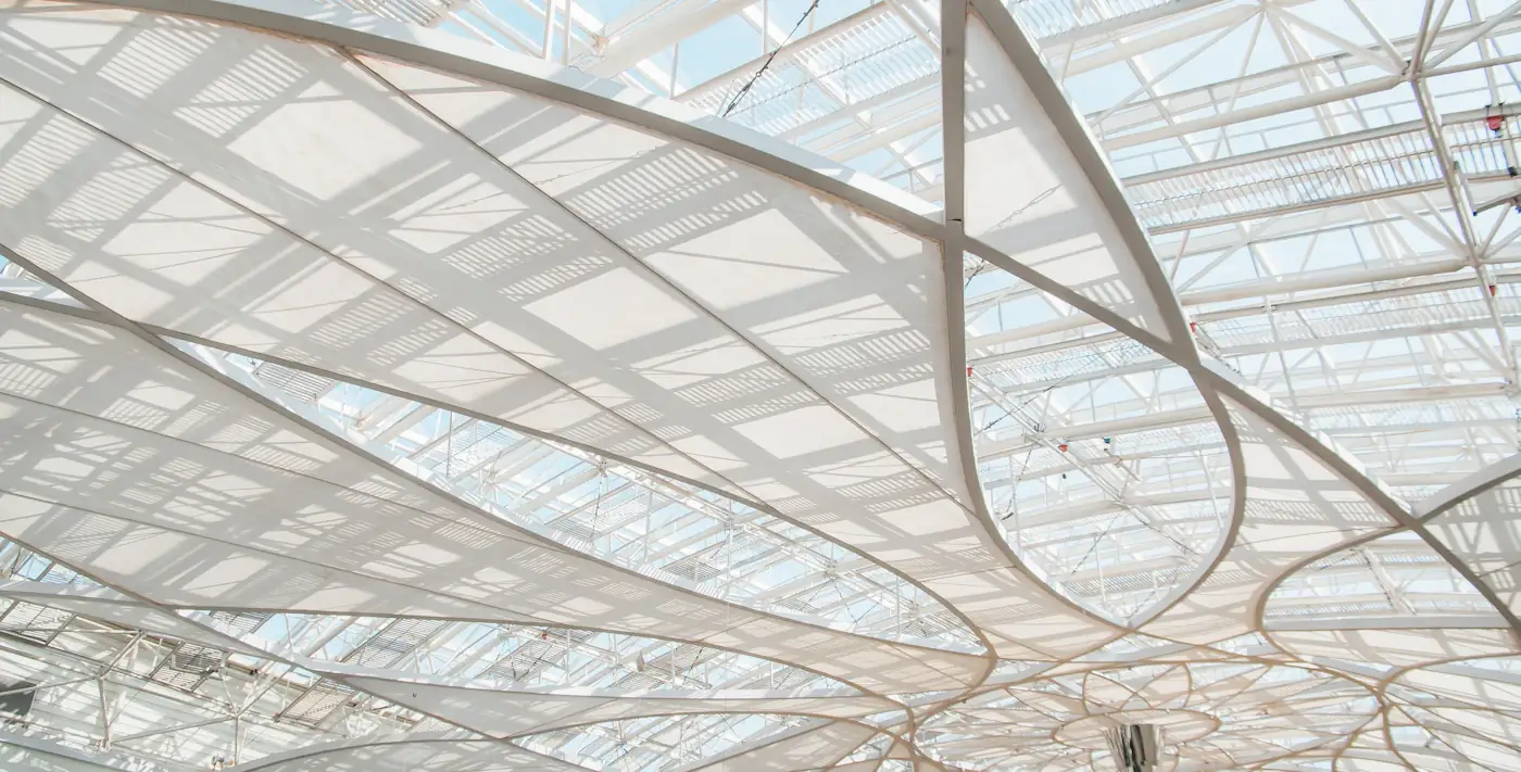 Covered courtyard beneath a geometric glass roof