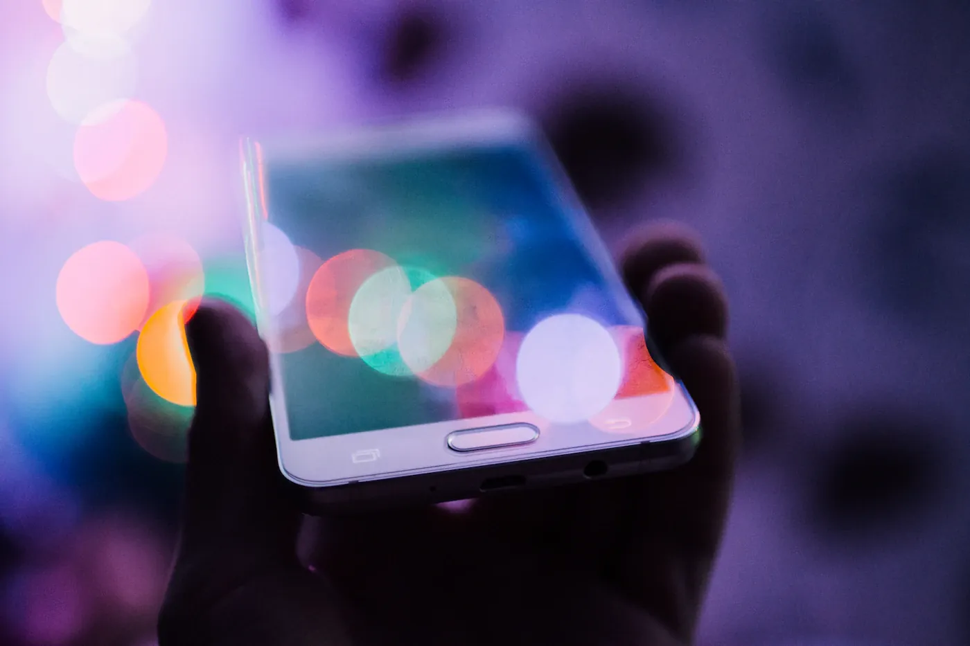 Person holding an illuminated smartphone