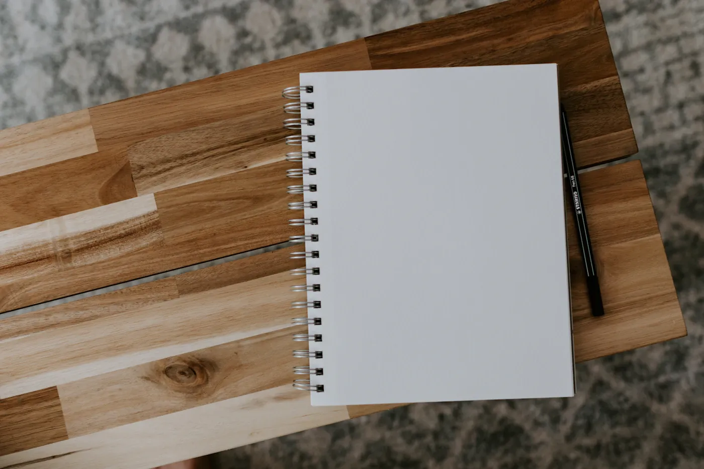 Blank spiral notebook on a wooden table