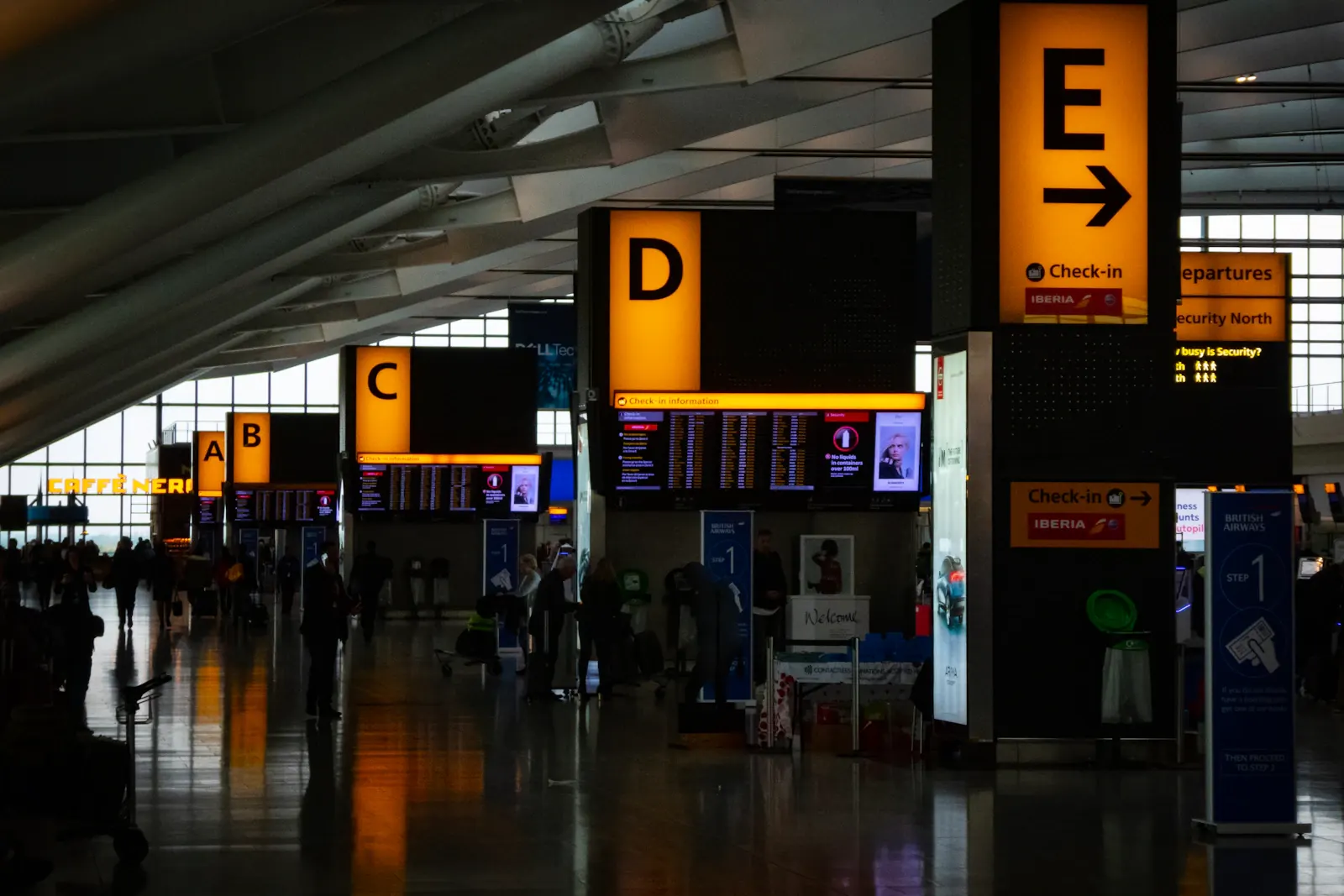 Illuminated wayfinding signs inside an airport terminal