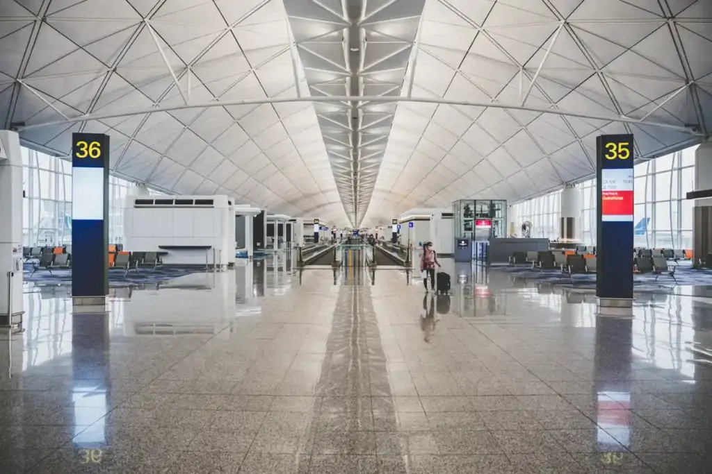 Bright airport concourse beneath a patterned roof