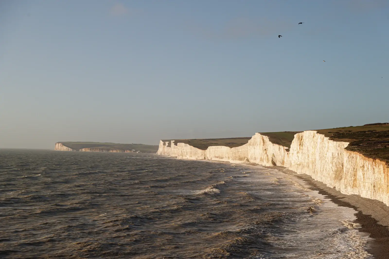 White coastal cliffs beside a blue-grey sea