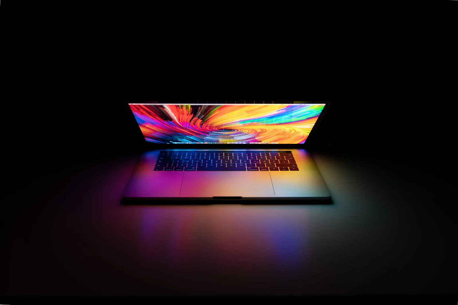 Illuminated laptop against a dark background