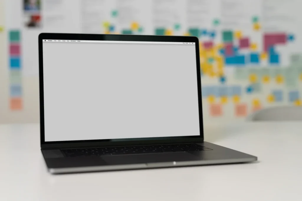 Laptop on a desk in front of colourful notes