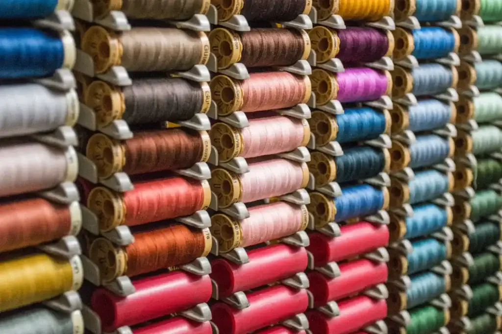 Spools of coloured thread on a rack