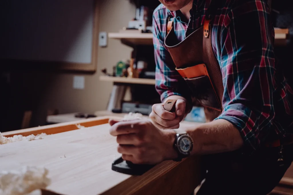 Furniture maker working on a wooden component