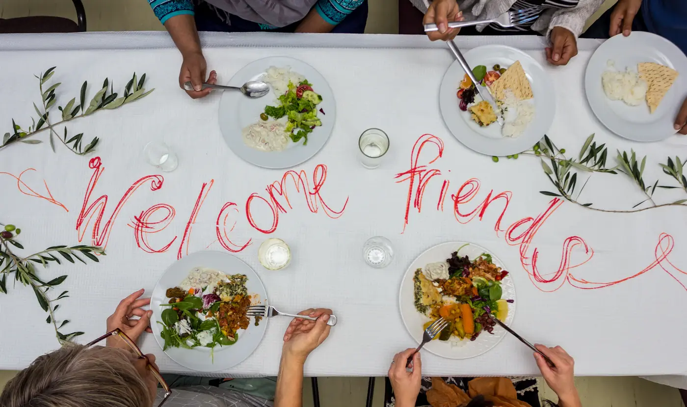 Guests seated around a decorated shared dining table