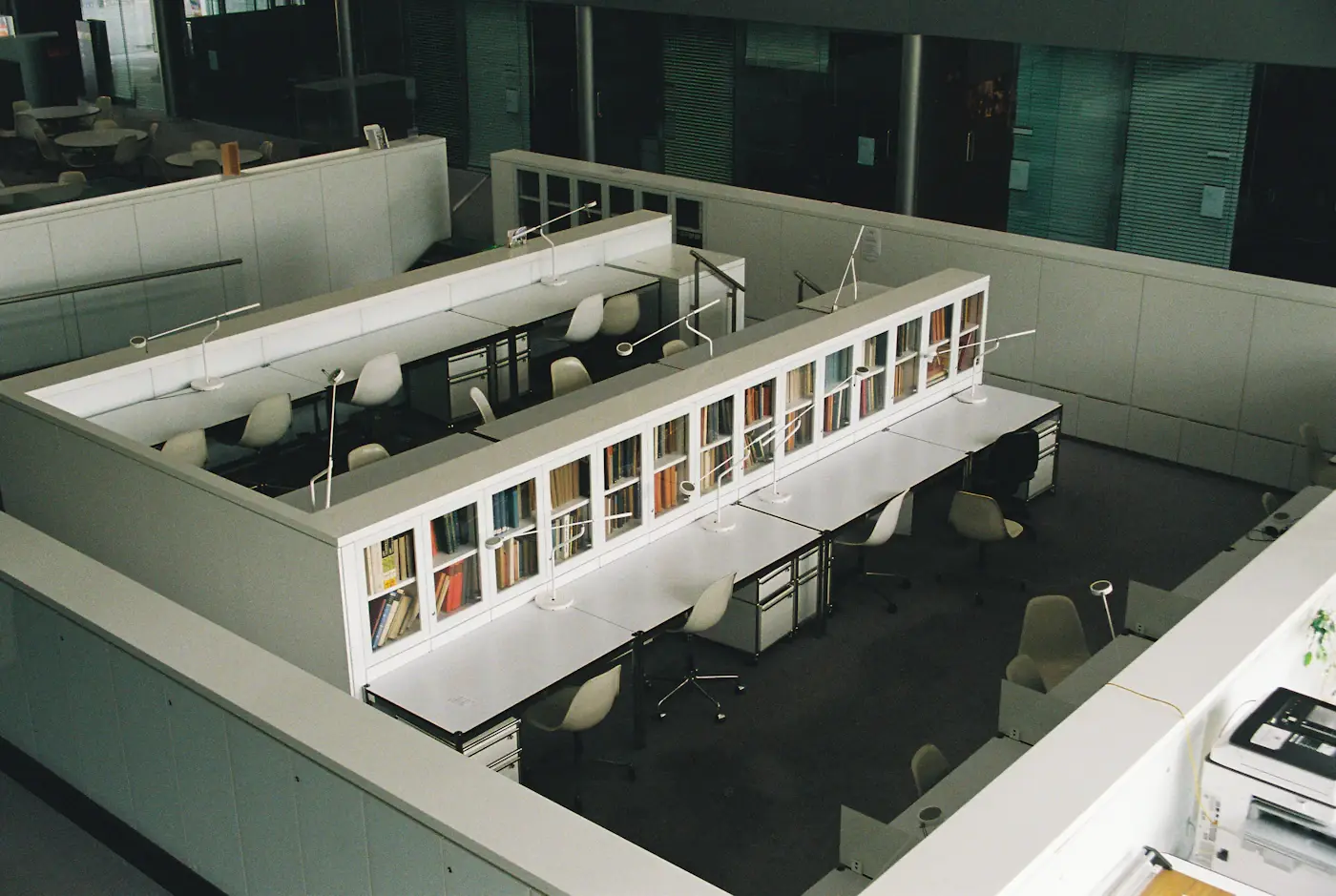 Tables and shelves inside a bright contemporary library