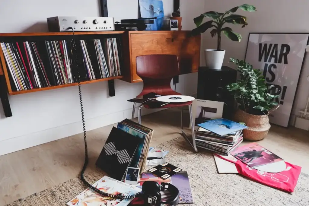 Vinyl records stored beside a listening setup