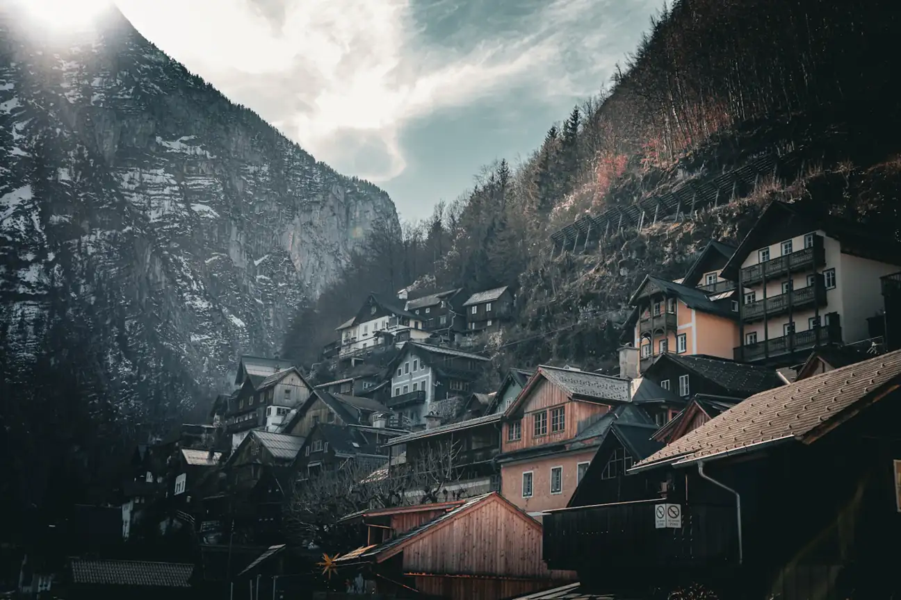 Mountain village beneath misty steep slopes