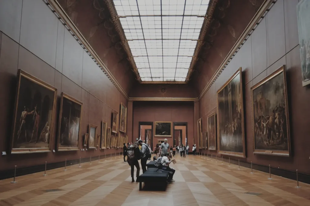 Visitors in a gallery beneath a large roof light