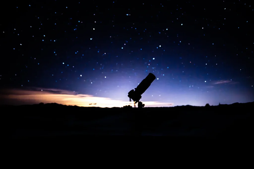 Telescope silhouetted against an evening horizon