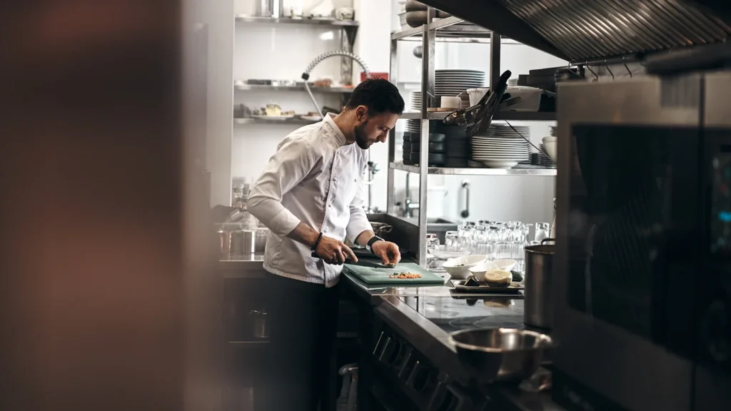 Chef working beside restaurant kitchen equipment