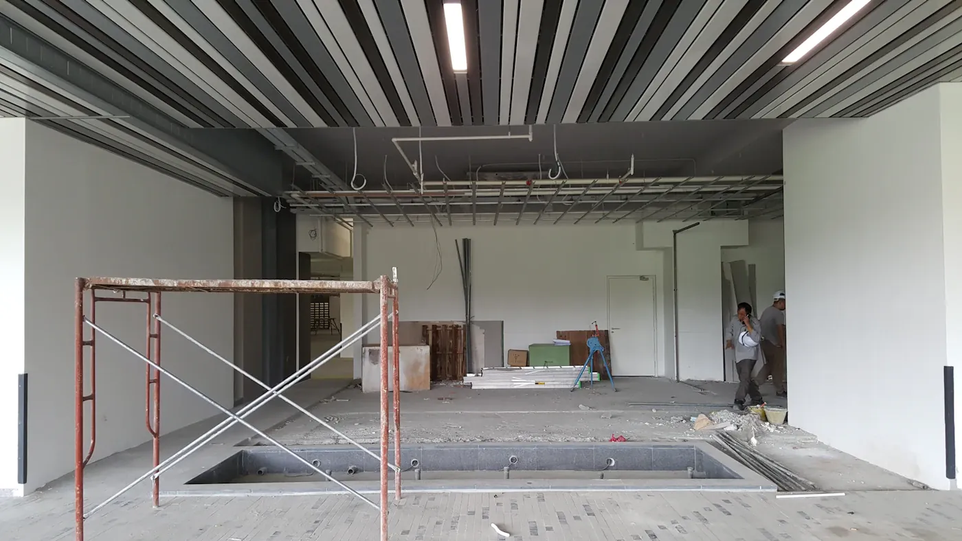 Partly renovated interior with exposed ceiling structure