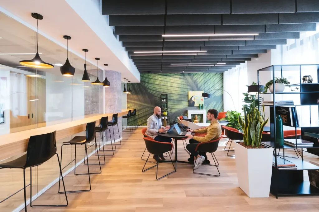 Open shared workspace with tables and pendant lights