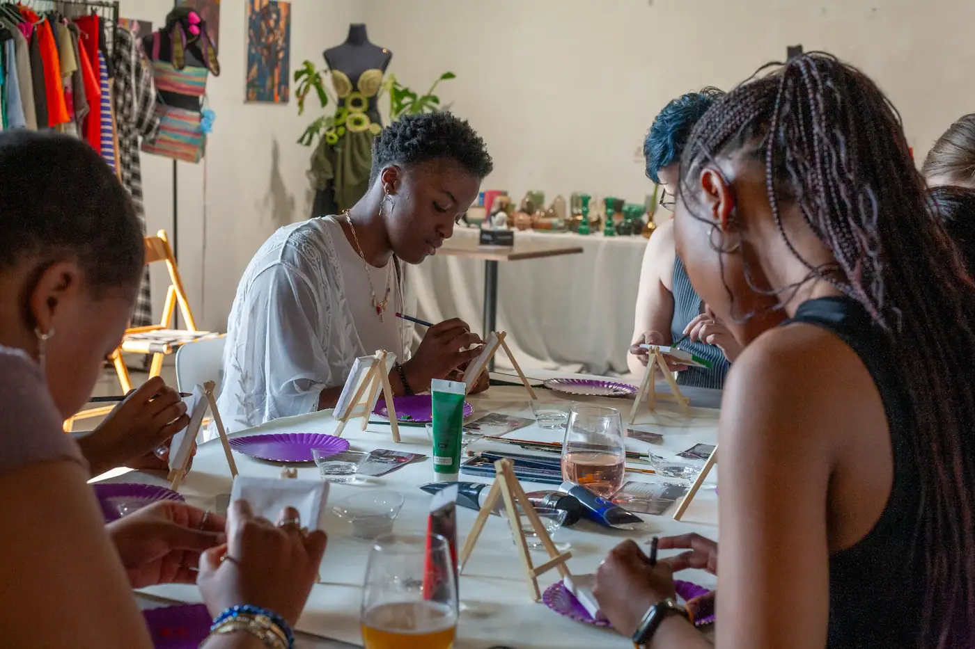 People painting together at a shared art table