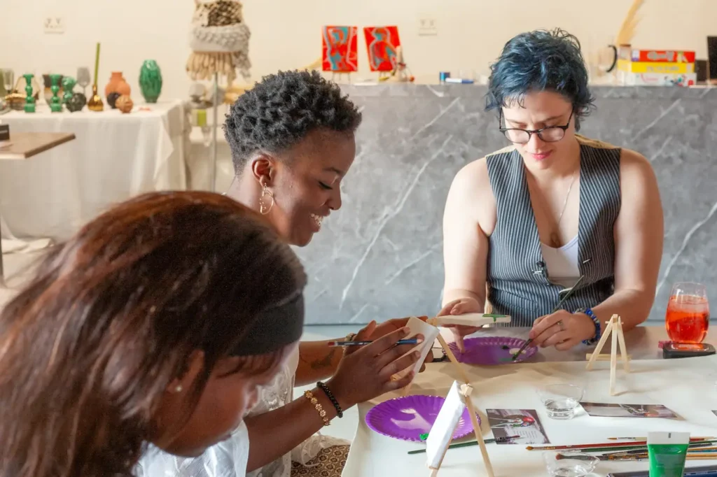 Participants working on paintings in an art workshop