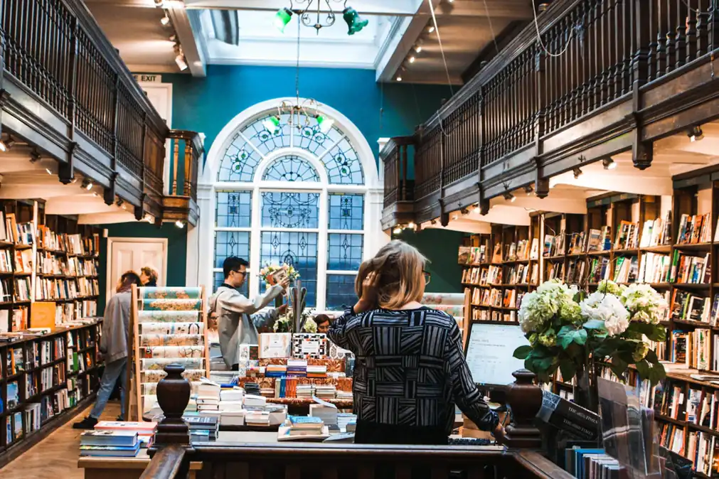 Readers and tables inside a bookshop