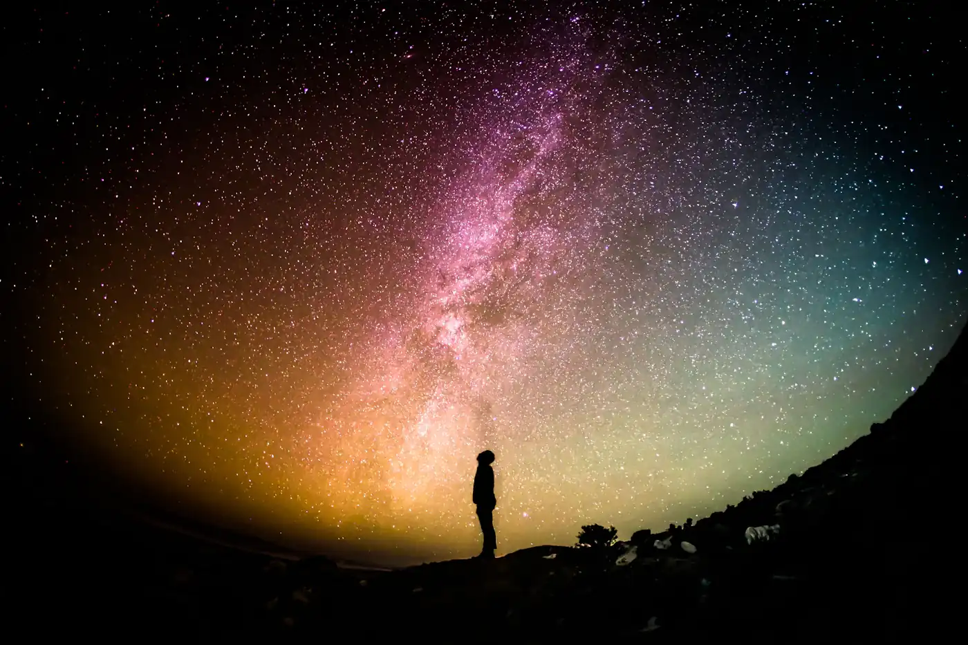 Silhouette beneath a bright band of stars