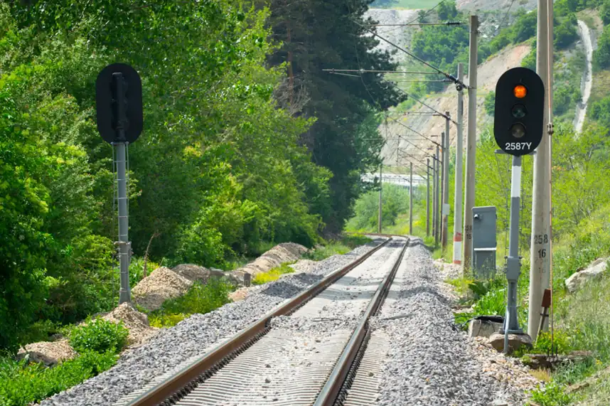Rail tracks curving through a green landscape