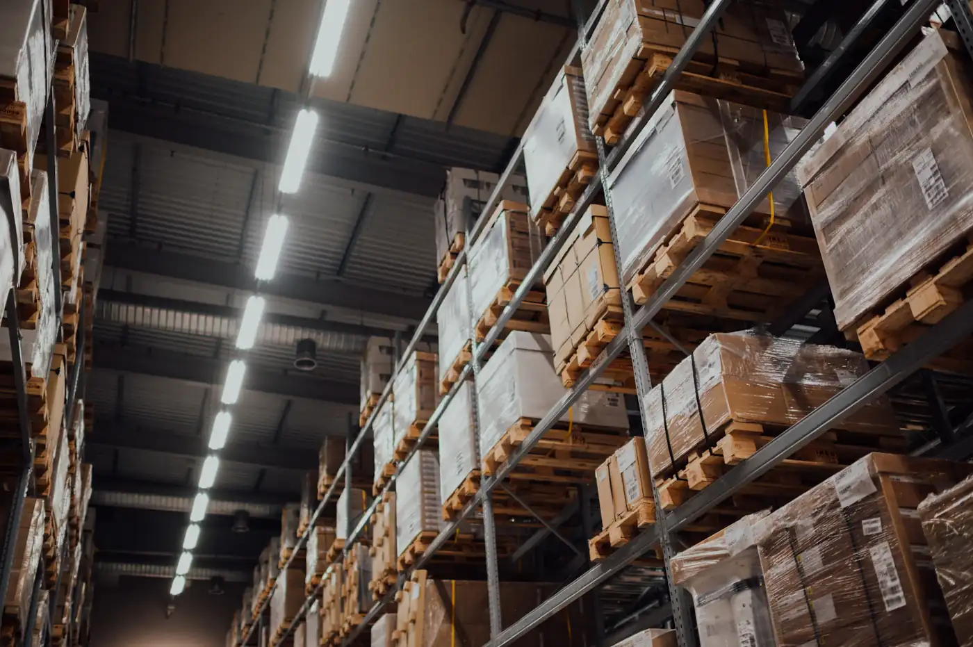 Warehouse aisle lined with boxes on tall shelves