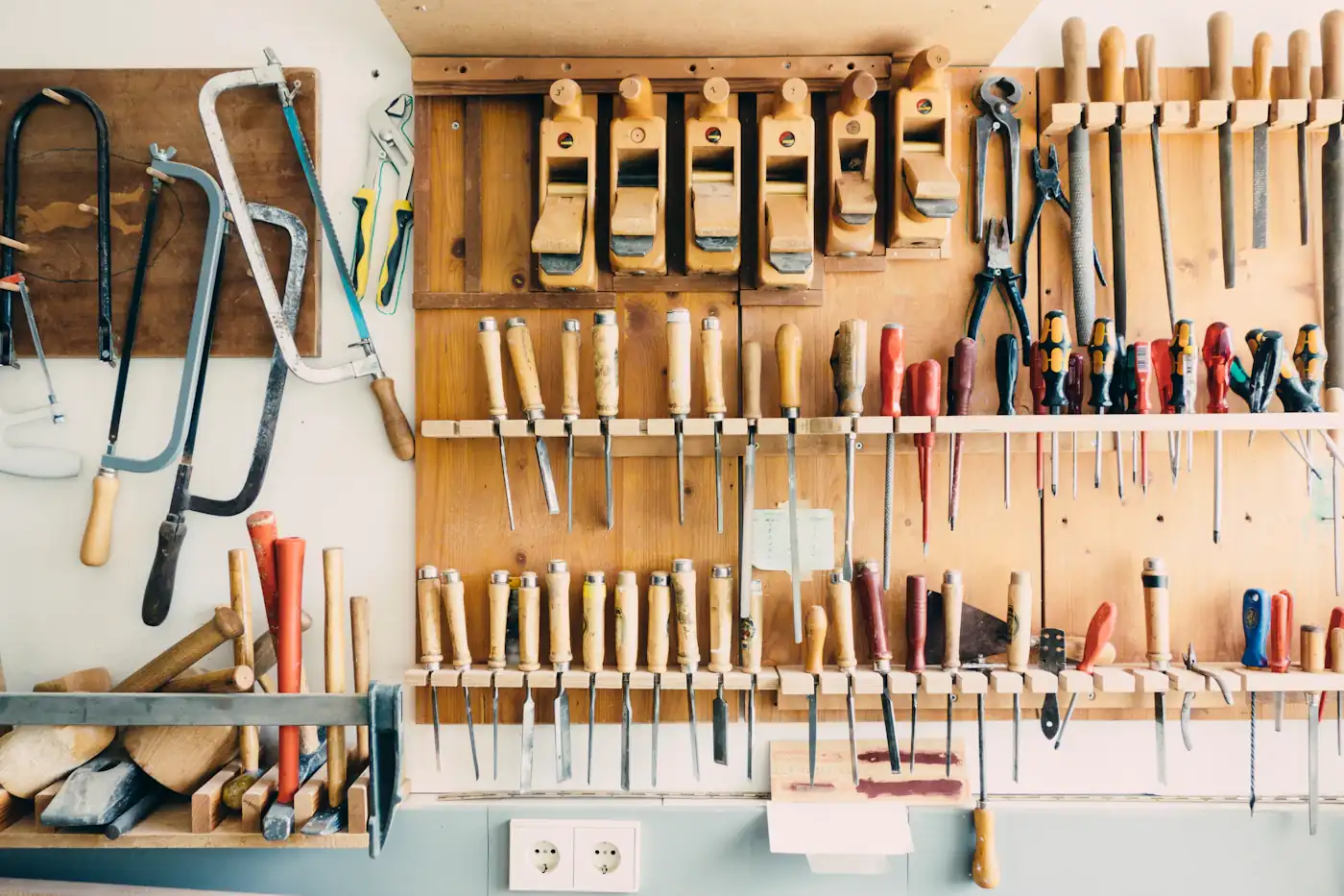 Hand tools organised on a workshop wall