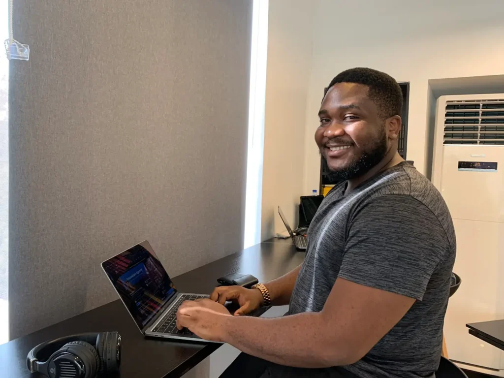 Person working at a laptop in a home workspace