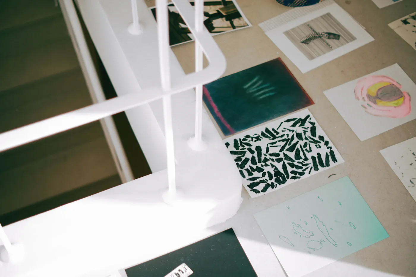 Prints and artwork arranged on a studio desk