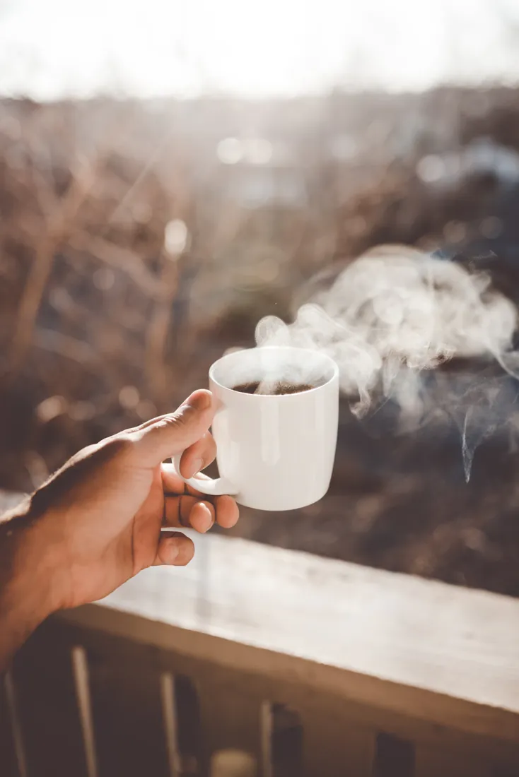 Steam rising from a mug held in a hand