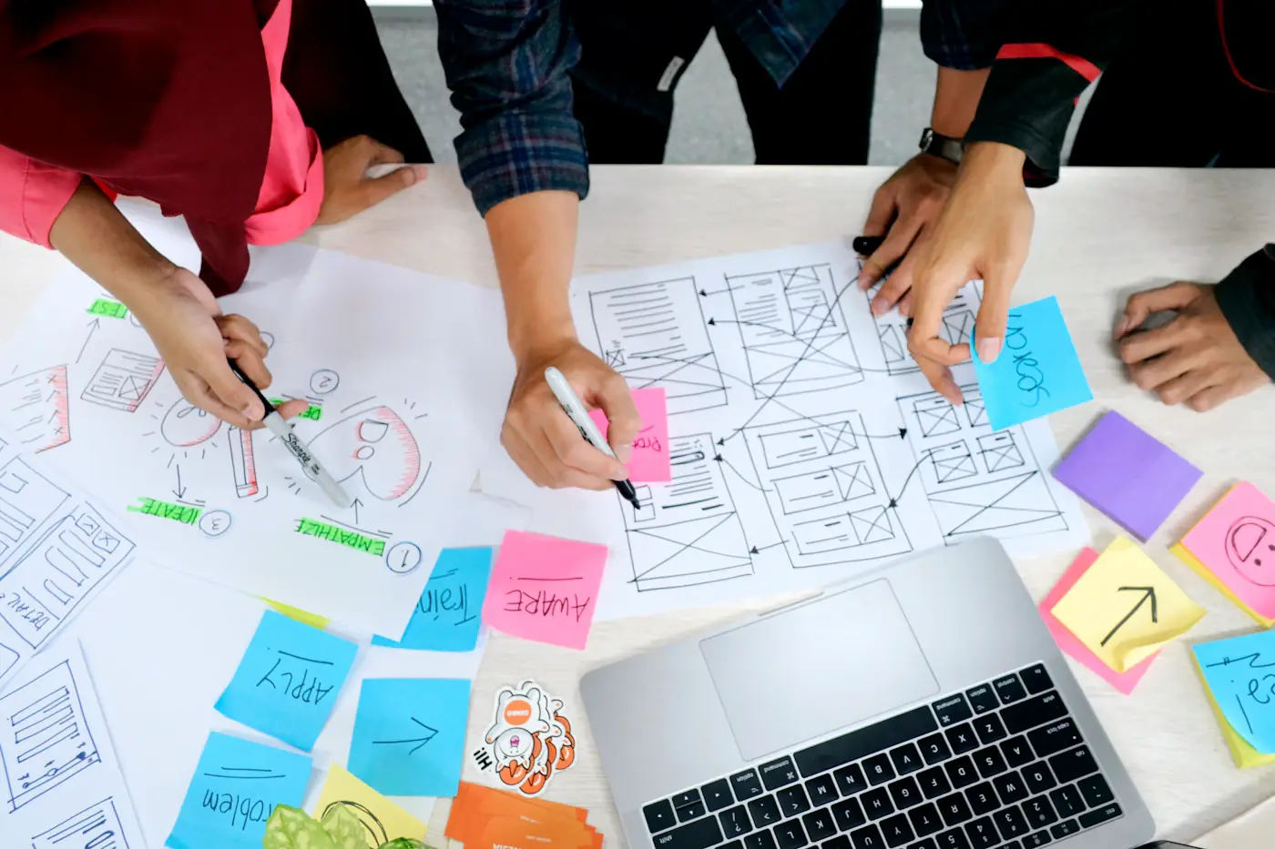 Team working with paper plans and sticky notes