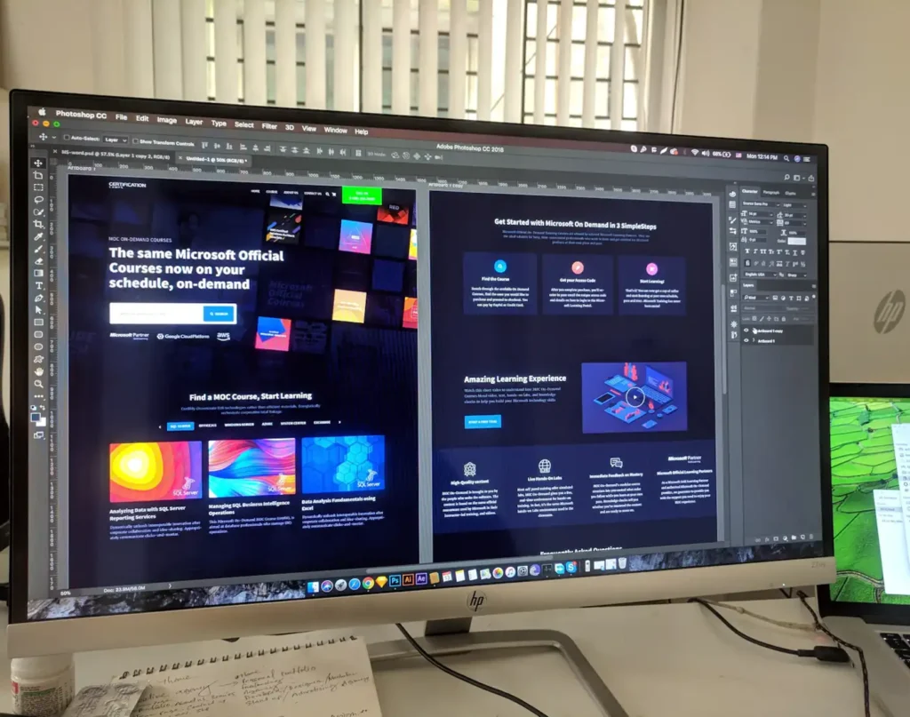 Website designs displayed on a large monitor