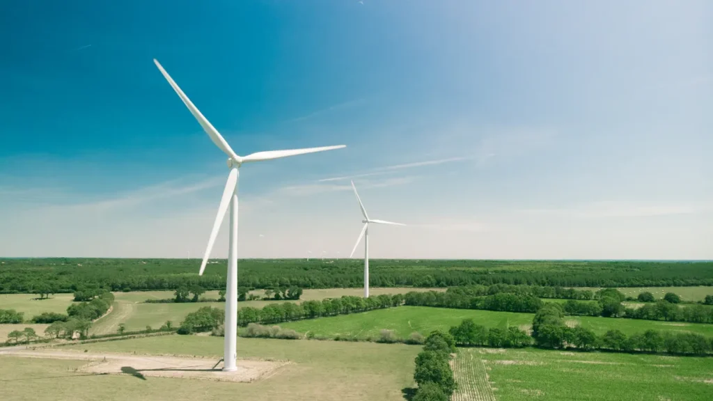 Wind turbine above cultivated green fields